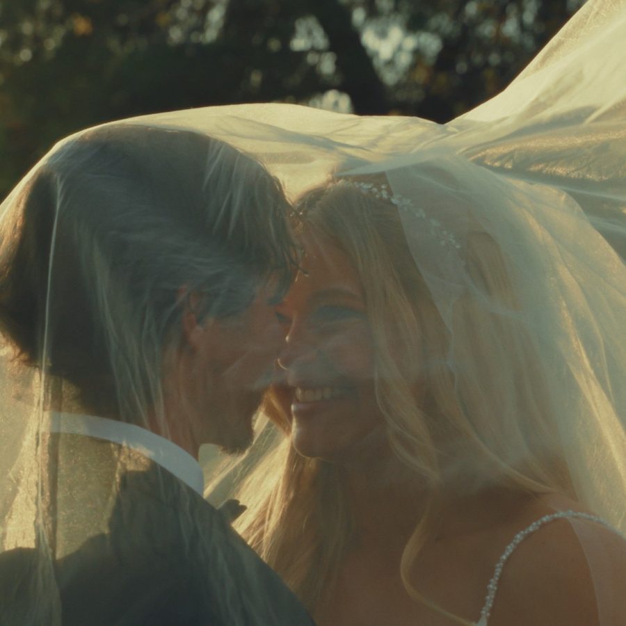 Couple laughing together under a windblown veil